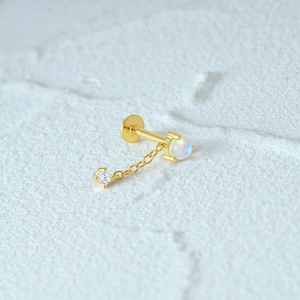 Macro shot of 16G gold S925 silver flat back earring with opal chain and zircon stone