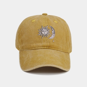 Detail of vintage ginger yellow sun and moon embroidered washed cotton baseball cap