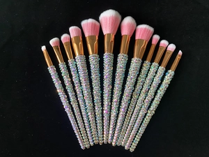 Detail of 12-piece makeup brush set with sparkling rhinestone handles and pink bristles