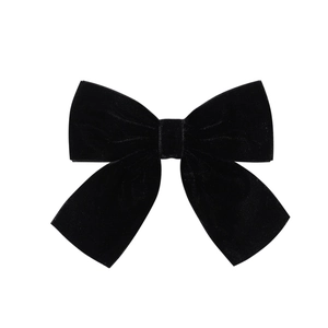 Close-up of black velvet bow hair clip showing soft fabric texture and double-layered design
