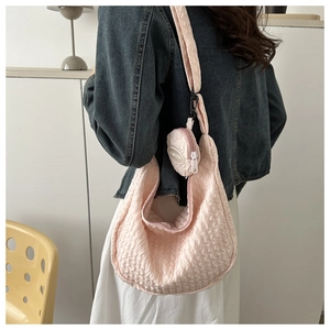 Pink bubble textured shoulder bag detail with a small round detachable fashion pouch