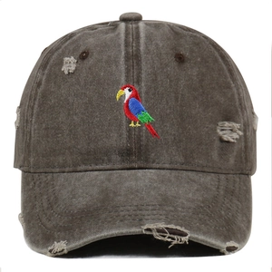 Distressed brown washed cotton baseball cap featuring colorful parrot embroidery and ripped details