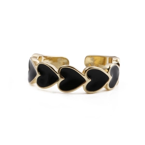 Detail of gold-plated open ring featuring a row of black enamel heart patterns