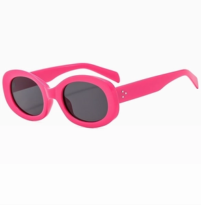 Detail of bright pink oval sunglasses with silver triple-dot accents on side temple