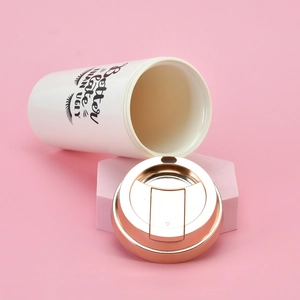 Detail of insulated coffee cup with 'Better late THAN UGLY' print and rose gold lid