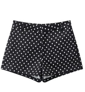 Detailed view of high-waisted black and white polka dot shorts with side pockets