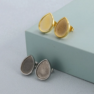Fashionable stainless steel teardrop stud earrings in gold and gunmetal finish