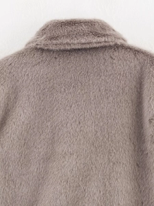 Detailed macro view of the soft faux fur texture on this mauve fleece jacket
