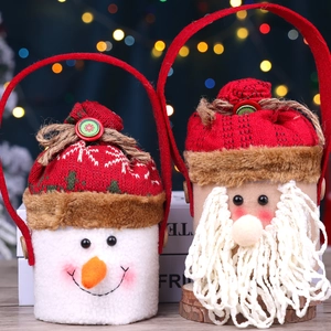 Detail of plush Santa and Snowman gift bags with red knitted hats and festive textures