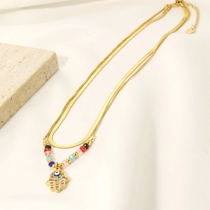 Double-layered gold necklace with colorful beaded chain and Hamsa Hand evil eye pendant