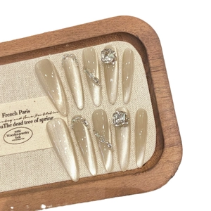 Press-on nail set with champagne cat-eye texture, rhinestones, and long trapezoid shape