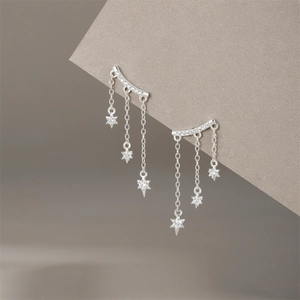 Detailed close-up of S925 sterling silver tassel earrings with sparkling star pendants