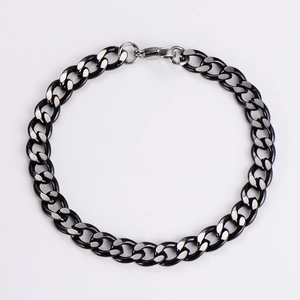 Detail of 7mm two-tone silver and black stainless steel Cuban link bracelet with lobster clasp