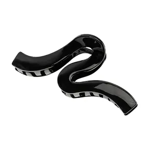 Minimalist large black hair claw clip featuring a unique S-shaped wave geometric design