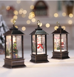 Close-up of vintage bronze Christmas lanterns with snowman and Santa Claus motifs