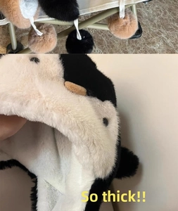 Detail of the thick plush lining and soft faux fur of this cute penguin earflap hat