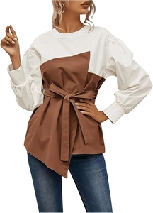 Detail of color-block puff sleeve blouse with waist tie and bicolor paneling design