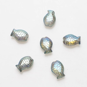 Close-up of 6 fish-shaped iridescent glass charms for DIY jewelry making and beading