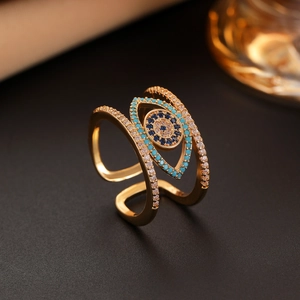 Macro shot of gold-layered wrap ring featuring evil eye motif with blue zircon stones