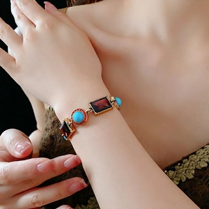 Vintage gold tone bracelet with red stones and blue turquoise beads for women