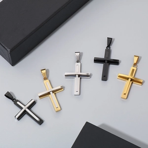 Detailed view of polished cross pendants in black, gold, and silver stainless steel