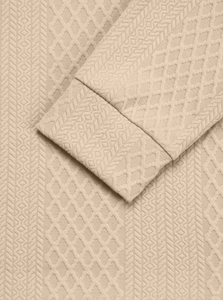 Macro detail of beige long sleeve polo set featuring premium 3D geometric knit texture