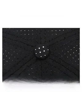 Detailed top view of a black breathable fabric baseball cap showing reinforced seams