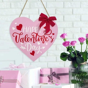 Pink heart wooden sign with Happy Valentine's Day text and ribbon for wall hanging decor