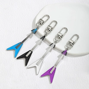 Set of four guitar keychains in blue, black, white, and purple enamel with metal finish