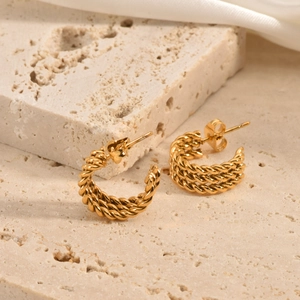 Detailed view of dainty 18k gold plated stainless steel triple twist C-hoop earrings.