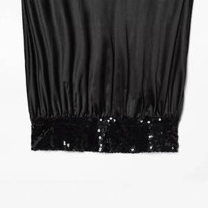 Fashionable black strapless top with sequin trim and smooth satin fabric finish