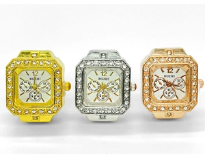 Detail of square quartz ring watches in gold, silver and rose gold with rhinestone bezels