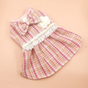 Detailed view of pink tweed pet dress with elegant pearl belt and lace trim