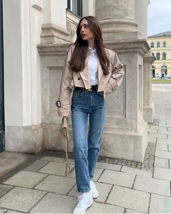 Dettaglio della giacca a vento corta kaki con jeans a vita alta e una cintura