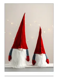 Detail of red and grey knitted Christmas gnomes with fluffy white faux fur beards