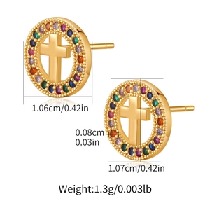 Detailed view of gold earrings with a cross design and colorful zircon stones