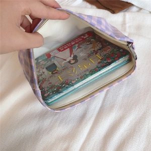 Macro detail of the spacious purple plaid cotton bag interior with zipper closure