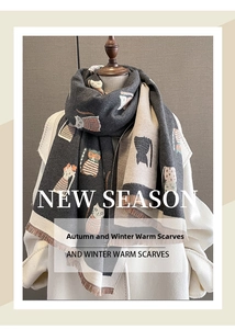 Detailed view of thick cashmere-like scarf with cartoon cat patterns and brown tassels