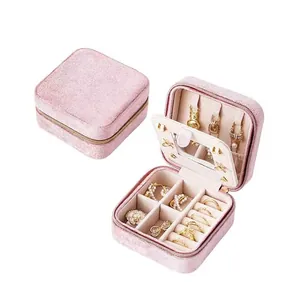 Portable pink velvet jewelry box with mirror, zipper closure, and multi-layer storage