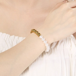 Adjustable stainless steel bead bracelet with imitation pearls worn on woman's wrist