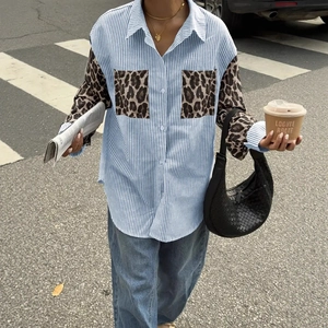 Close-up of casual striped shirt featuring leopard print pocket and sleeve details