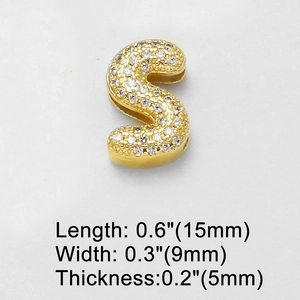 Macro shot of gold letter S charm with white cubic zirconia pavé setting detail
