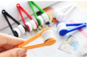 Macro shot of portable eyeglass cleaning clips with microfiber heads in various colors