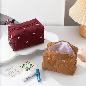 Quilted makeup bag set with white bow embroidery in burgundy and ginger yellow colors