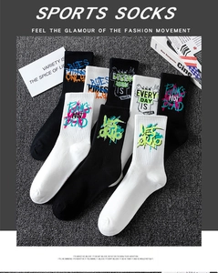 Detailed close-up of graffiti sports socks with street style patterns on asphalt