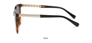 Detail view of retro tortoiseshell sunglasses featuring gold temples and white pearl inlay
