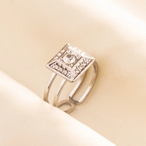 Macro shot of silver square ring face with round stone and adjustable double band