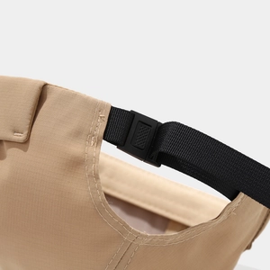 Detail of khaki ripstop fabric and adjustable black buckle on a minimalist docker cap