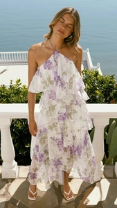 Detail view of tiered chiffon dress featuring purple wisteria floral print and ruffles