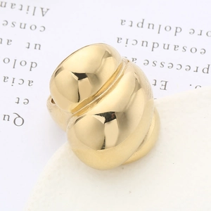 Macro detail of 18k gold plated stainless steel croissant ring with twisted texture